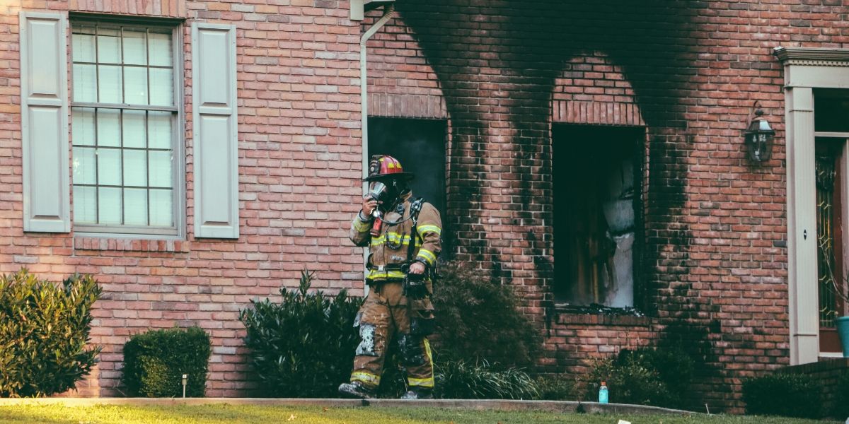 Fireman walking away from house after a fire